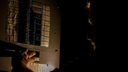 Man checking electrical panel box