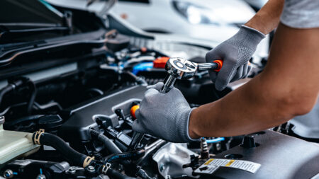 Mechanic under car hood