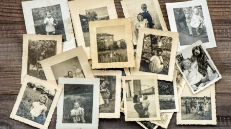 Old family photos scattered on table