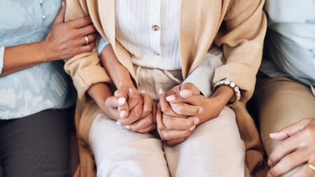 People holding hands support empathy grief