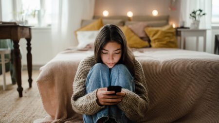 Teen girl staring at phone screen