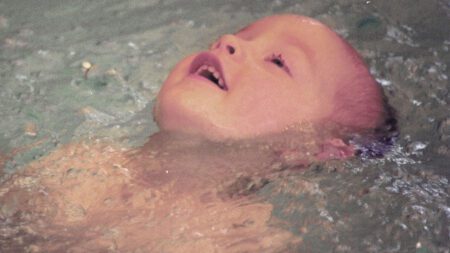 Young boy swimming Blue Buoy Family Swim School