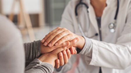patient doctor holding hands behavioral health