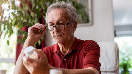 Senior man looking at prescription medication