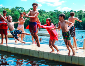 jumping off dock Stk-YMCA of the Pines-Medford Living