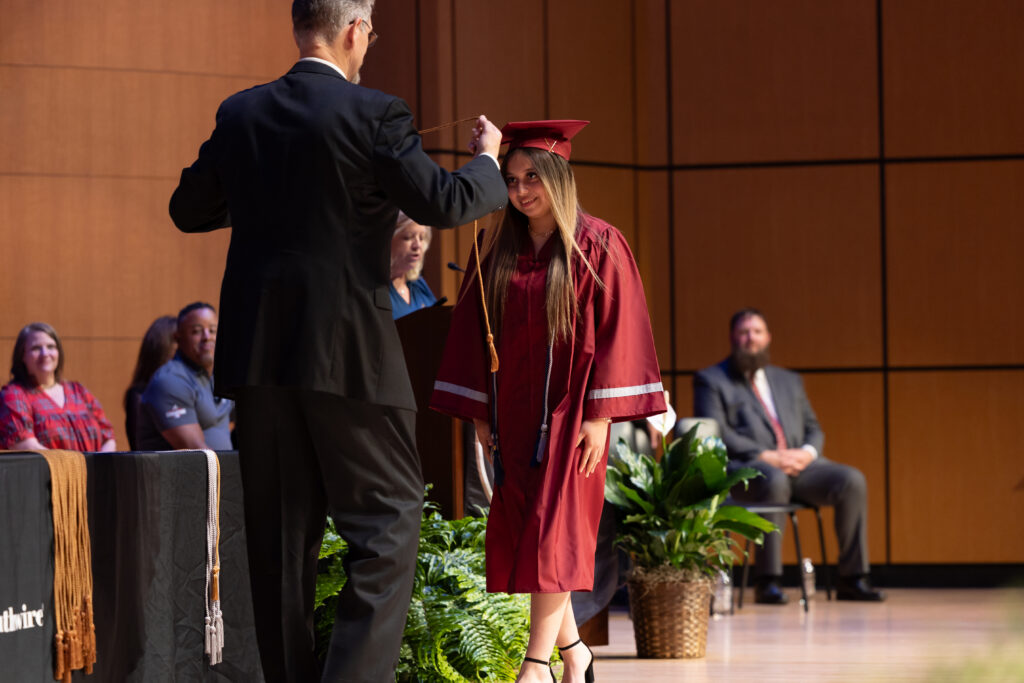 12 for Life graduate walking across stage