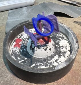 Ross Goldsmith setting up the wax model to be securing in casting plaster