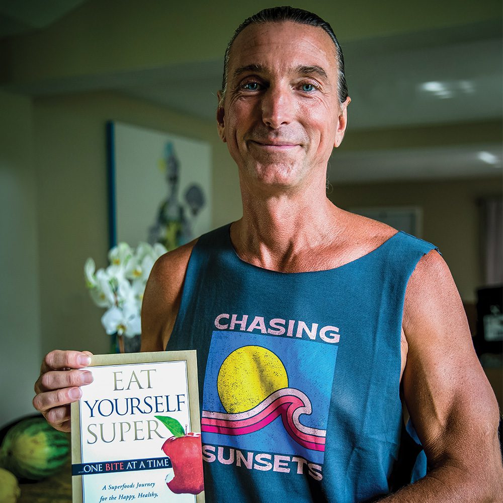 Dr. Todd Pesek, MD holding book VitalHealth Partners