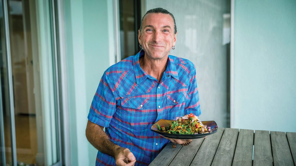 Dr. Todd Pesek, MD with plate of food VitalHealth Partners