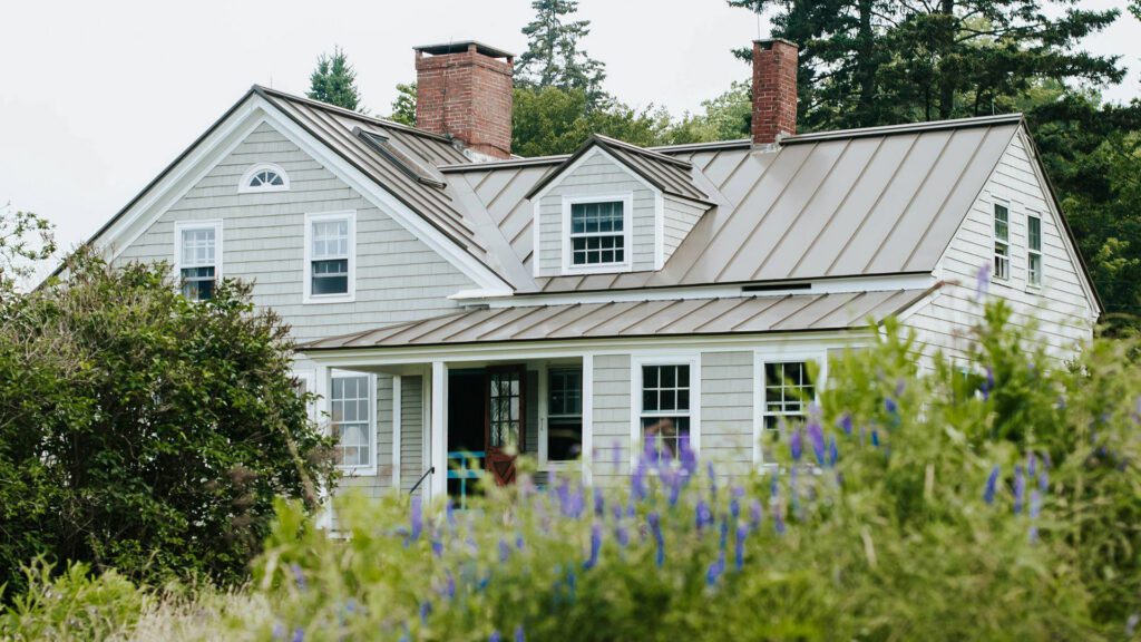 Home behind flowers and bushes Dream House Solutions