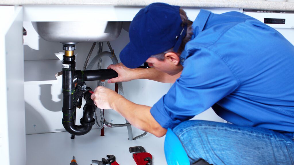 Plumber repairing pipe