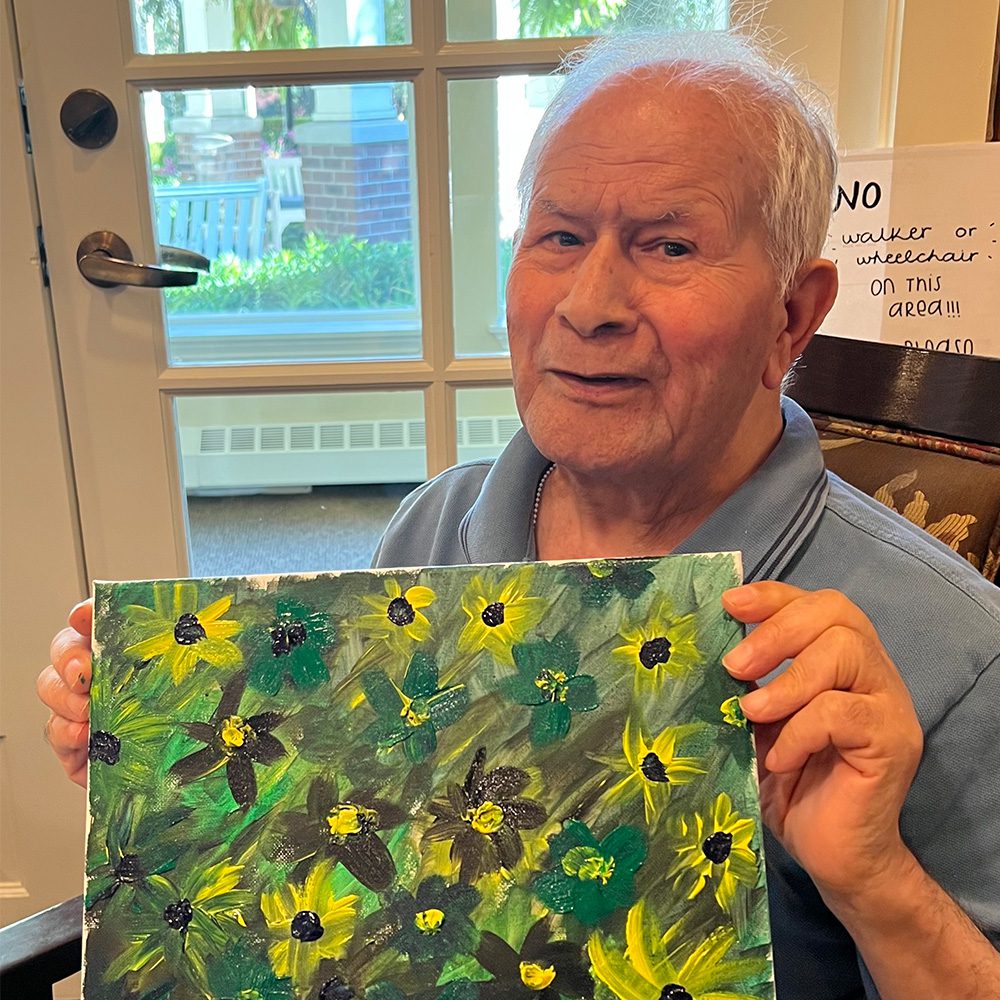 Senior man holding painting Sunrise of Lynn Valley