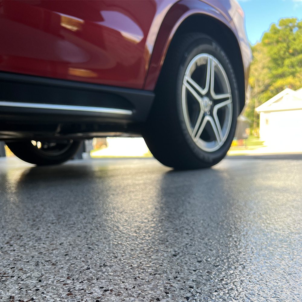 Car tires on epoxy garage floor GFC Concrete Coatings