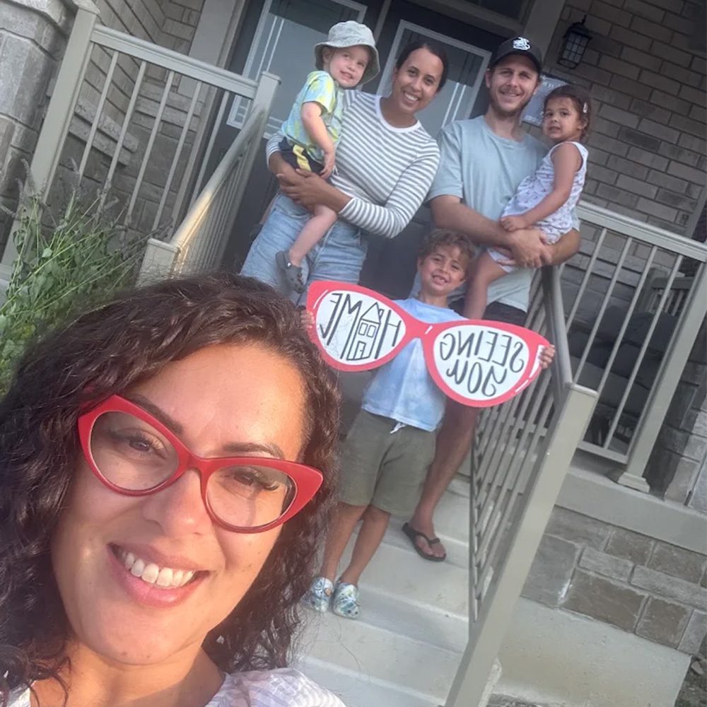 Family in front of sold home RE MAX Twin City Realty - Seeing You Home