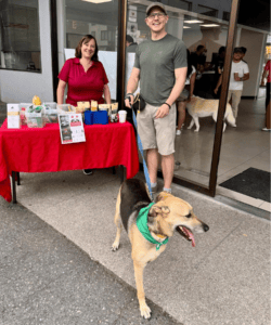 dog and owners at table North Shore Mitsubishi 