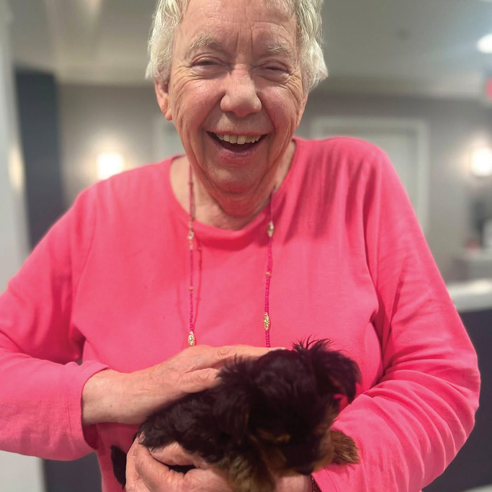 Senior woman holding puppy Waltonwood University