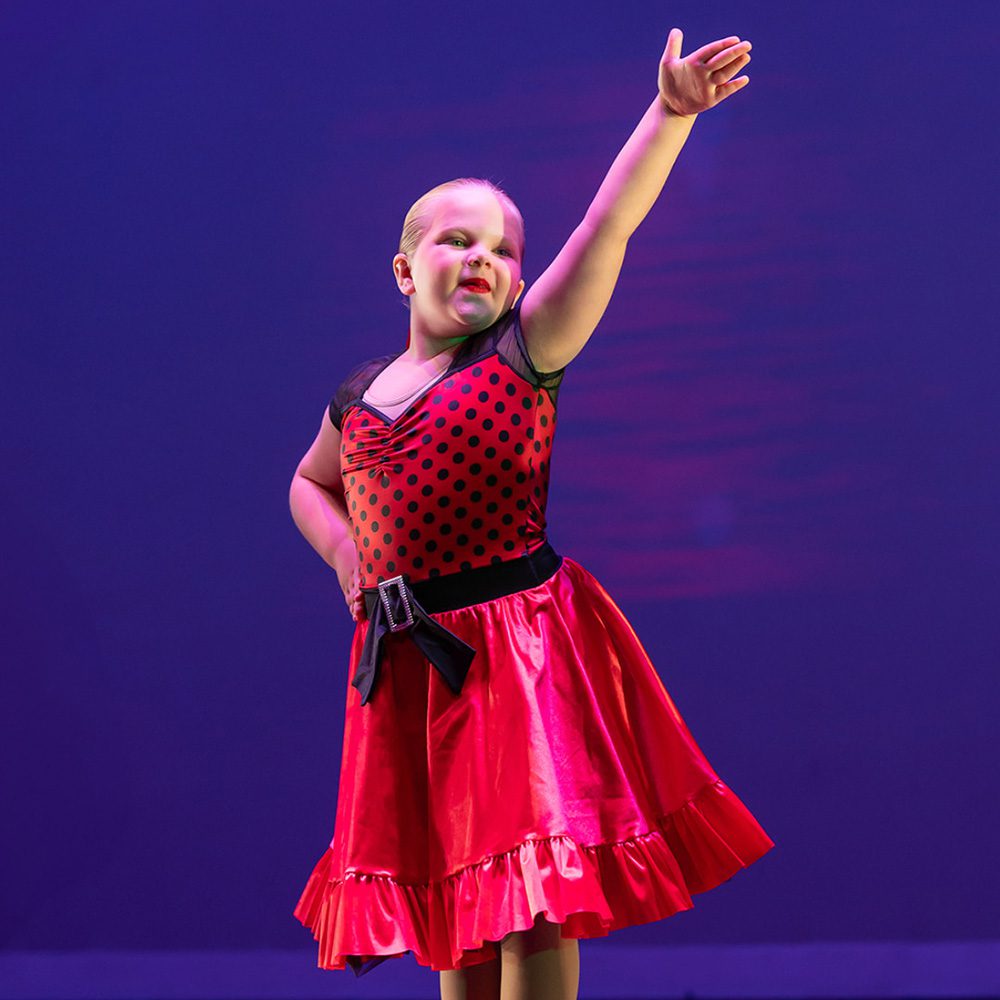 Young girl posing on stage EMC Performing Arts Studio