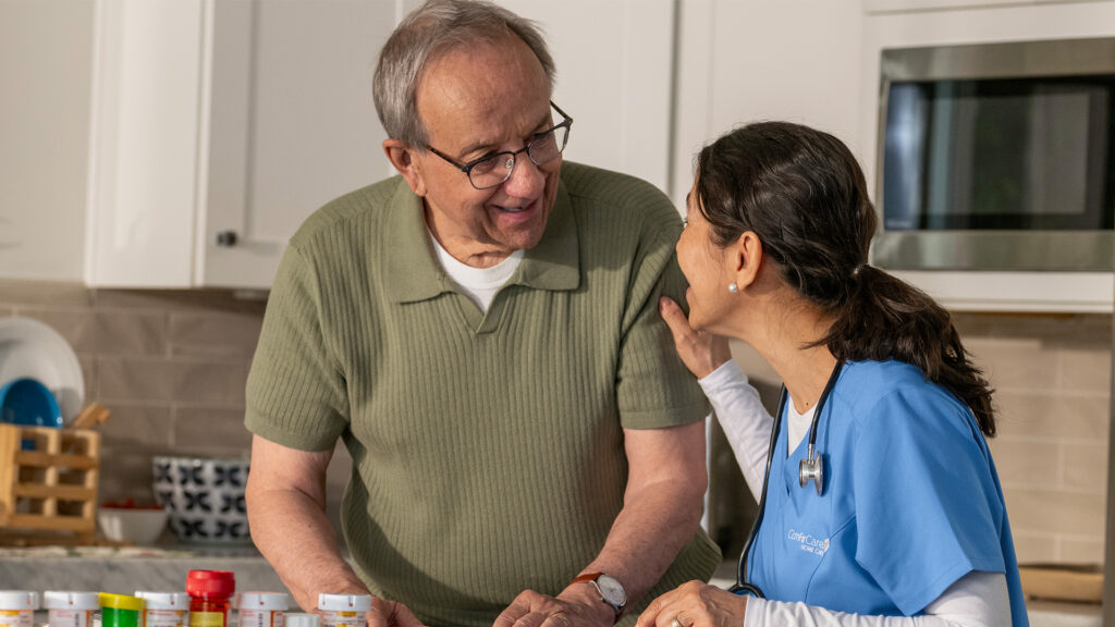 Caregiver sorting pills with senior man ComForCare Home Care of Minnetonka