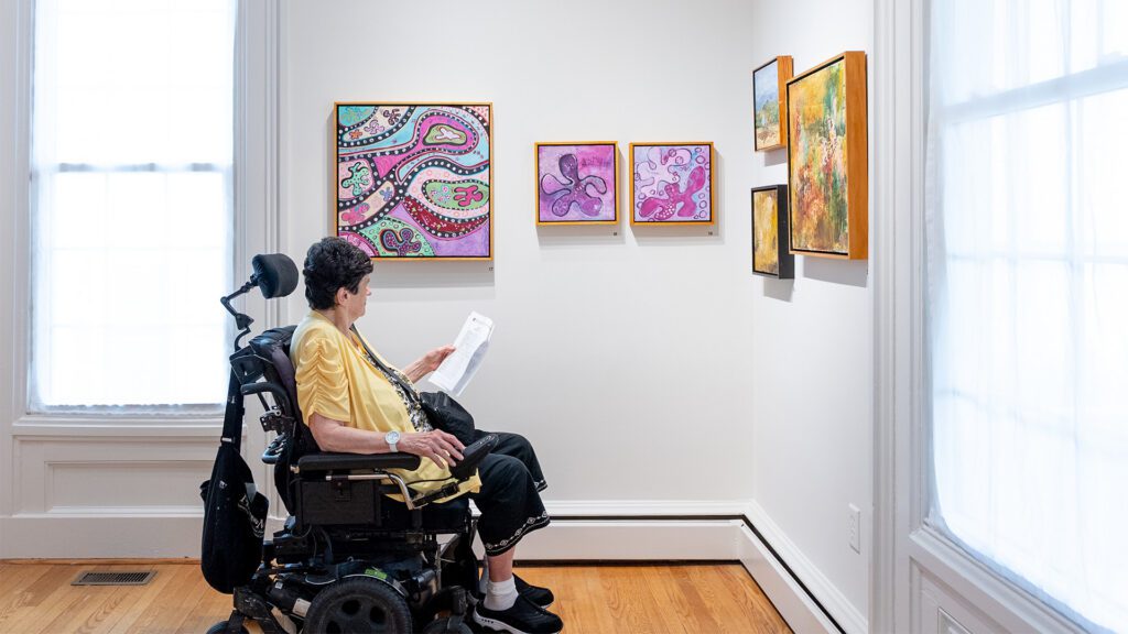 Woman looking at art on wall VMRC - Virginia Mennonite Retirement Community