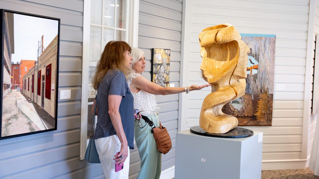 Women looking at art piece VMRC - Virginia Mennonite Retirement Community