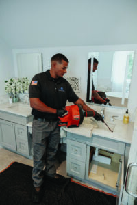 Titanium Plumbing and Heating Repair snaking toilet
