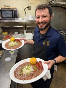 Caffe Latte Da staff member with dishes