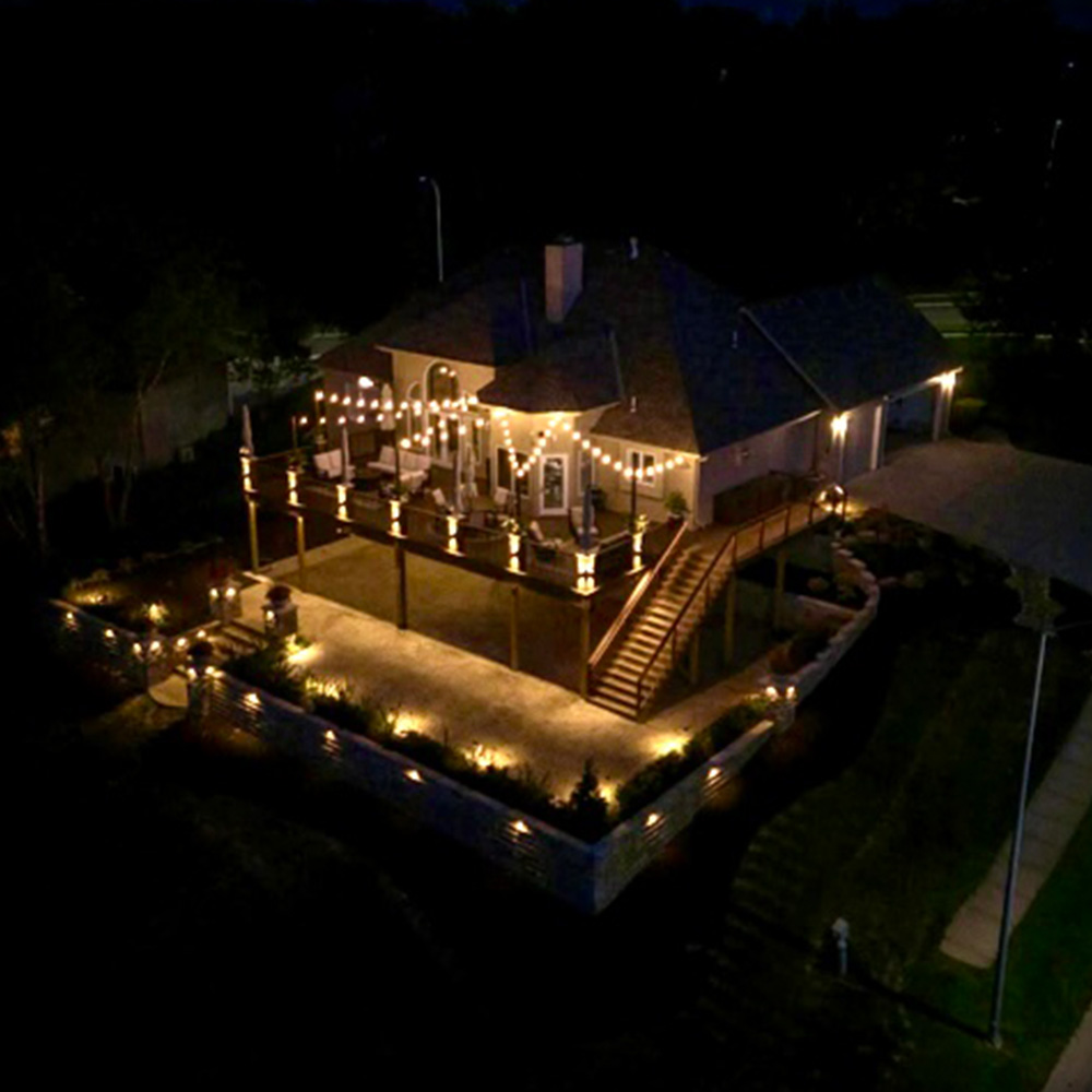 House with outdoor lighting Trey's Lawn & Landscape