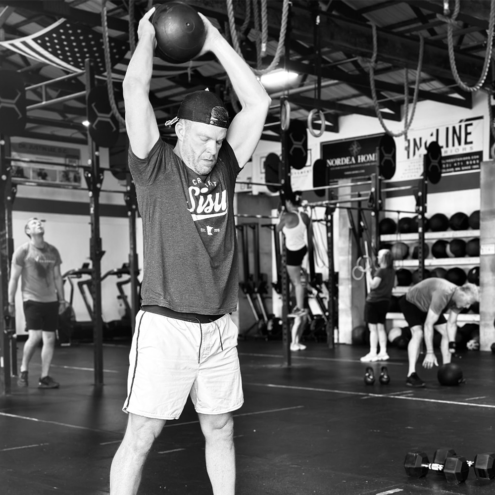 Man working out with medicine ball Crossfit SISU Excelsior