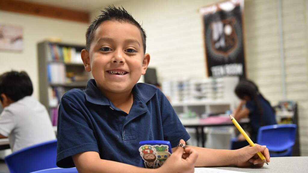 Student holding pencil at table PRCA South