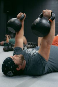 Tranzform Fitness Grand Haven man using kettle bells