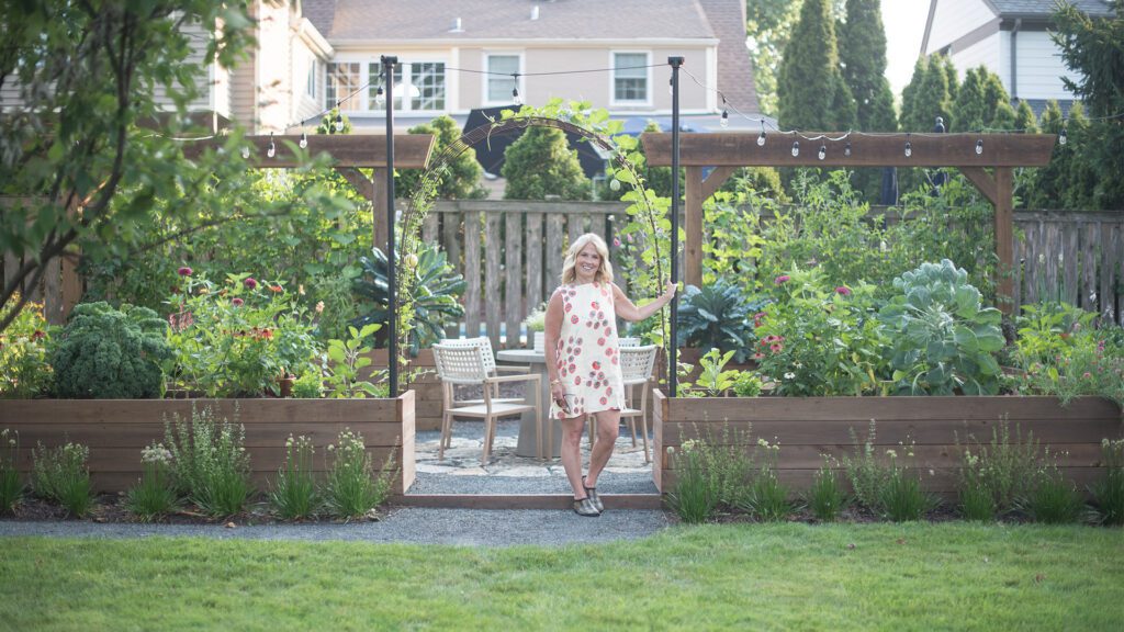Woman standing by garden Homegrown Gardens