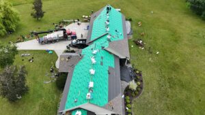 large home arial with lanscaping and driveway delivery Referred Roofing & Restoration